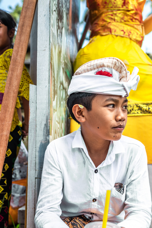BALI, INDONESIA - OCTOBER 9, 2018: Balinese boy in traditional clothes on culture ceremony, Ubud, Gianyar.のeditorial素材
