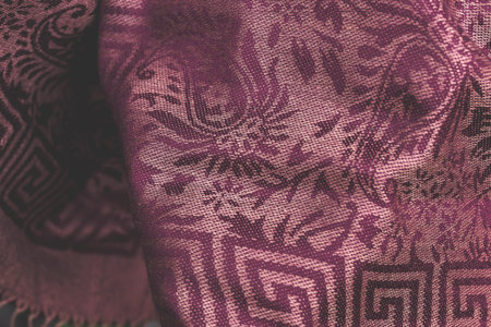 Woman wearing warm cashmere scarf on a tropical background. Asia.