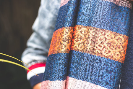 Woman wearing warm cashmere scarf on a tropical background. Asia.