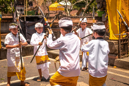 BALI, INDONESIA - OCTOBER 3, 2018: Balinese boys ritual dance in traditional costume on a balinese family ceremony in desa Pejeng Kangi.のeditorial素材