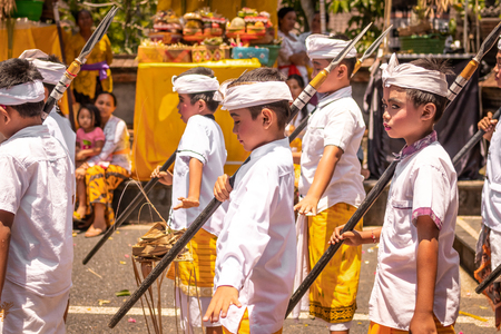 BALI, INDONESIA - OCTOBER 3, 2018: Balinese boys ritual dance in traditional costume on a balinese family ceremony in desa Pejeng Kangi.のeditorial素材