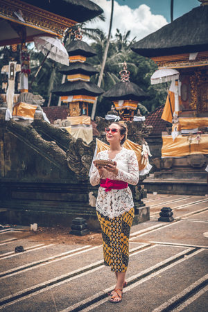 BALI, INDONESIA - DECEMBER 26, 2018: European woman in traditional dress on balinese ceremony in Ubud.のeditorial素材