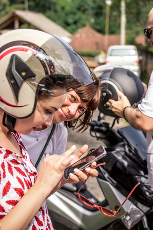 BALI, INDONESIA - DECEMBER 26, 2018: Young woman wearing motorbike helmet. Bali island.のeditorial素材