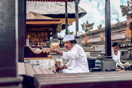 BALI, INDONESIA - DECEMBER 26, 2018: Holy man praying on a traditional religious ceremony.