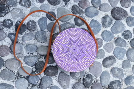 Fashion organic handmade rattan bag on a tropical background. Bali island.の写真素材