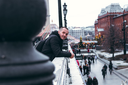 Young man on a russian red square background close to Kremlin. Moscow city.の写真素材