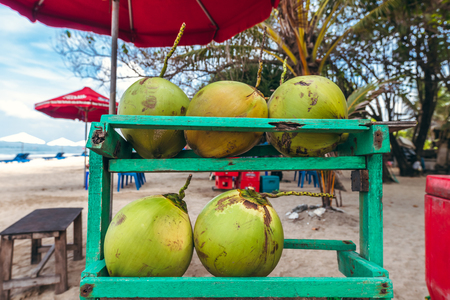 BALI, INDONESIA - FEBRUARY 19, 2019: Green and fresh organic coconuts on the beach.のeditorial素材