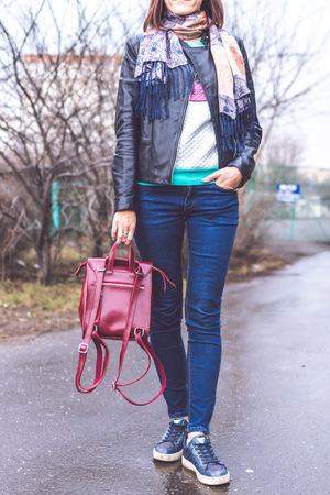 MOSCOW, RUSSIA - APRIL 10, 2019: Young woman with stylish hand painted backpack on the street. Modern City style.のeditorial素材