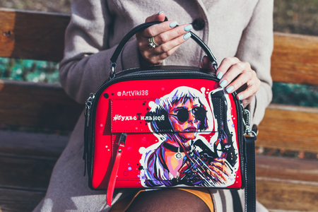 MOSCOW, RUSSIA - APRIL 5, 2019: Young woman with super fashion stylish hand painted bag on the street.のeditorial素材