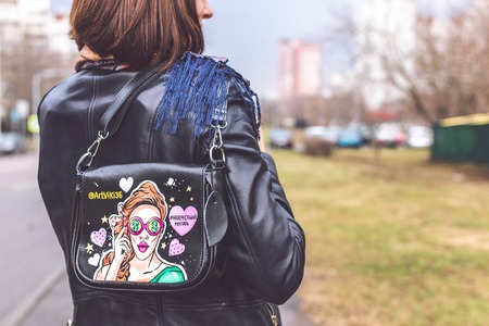 MOSCOW, RUSSIA - APRIL 5, 2019: Young woman with super fashion stylish hand painted bag on the street.のeditorial素材