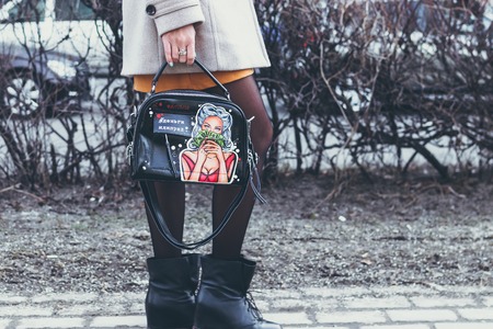MOSCOW, RUSSIA - APRIL 5, 2019: Young woman with super fashion stylish hand painted bag on the street.のeditorial素材