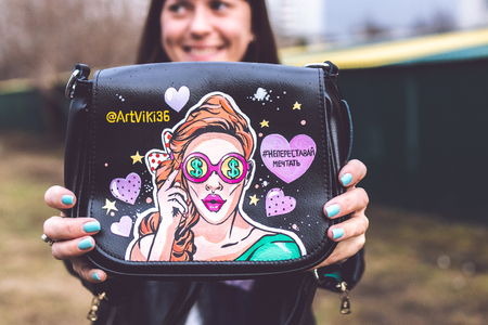 MOSCOW, RUSSIA - APRIL 5, 2019: Young woman with super fashion stylish hand painted bag on the street.のeditorial素材