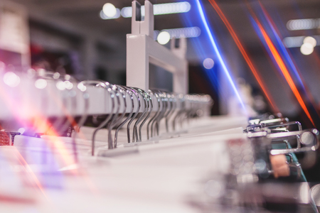 Close up shot of hangers in the retail store. Fashion shop. Clothes rack.の写真素材