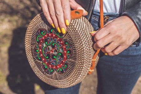 Woman hand with handmade organic rattan handbag. Rattan bag.の写真素材
