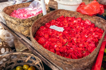 Flowers for traditional balinese offerings to gods on a local market. Bali island.の写真素材