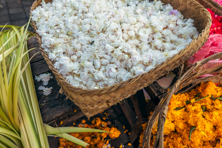 Flowers for traditional balinese offerings to gods on a local market. Bali island.の写真素材