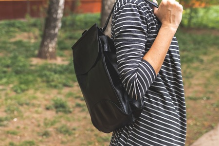 Woman with fashionable backpack on the street.の写真素材