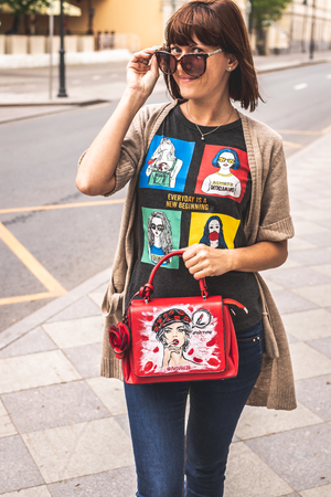 MOSCOW, RUSSIA - MAY 12, 2019: Woman with hand painted bag outdoors. Fashion trendy bag.のeditorial素材