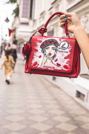 MOSCOW, RUSSIA - MAY 12, 2019: Woman with hand painted bag outdoors.のeditorial素材