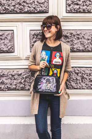 MOSCOW, RUSSIA - MAY 12, 2019: Woman with hand painted bag outdoors.