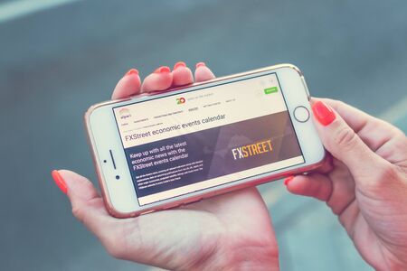 MOSCOW, RUSSIA - JUNE 4, 2019: Alpari financial company website on smartphone in woman hands.のeditorial素材