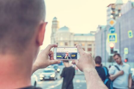 MOSCOW, RUSSIA - JUNE 4, 2019: Alpari financial company website on smartphone in man hands.のeditorial素材