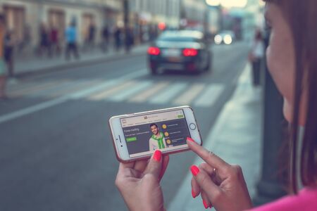 MOSCOW, RUSSIA - JUNE 4, 2019: Alpari financial company website on smartphone in woman hands.のeditorial素材
