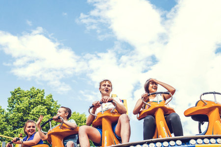 MOSCOW, RUSSIA - JUNE 2, 2019: Young couple of teenagers in amusement park.