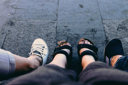 Four legs, 3 person. Shoes on the road.