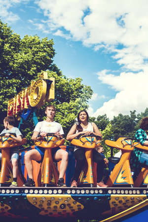 MOSCOW, RUSSIA - JUNE 2, 2019: Young couple of teenagers in amusement park.