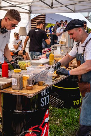 MOSCOW, RUSSIA - JULY 27, 2019: Group of men cooking bbq burgers at JohnCalliano hookah fest.のeditorial素材