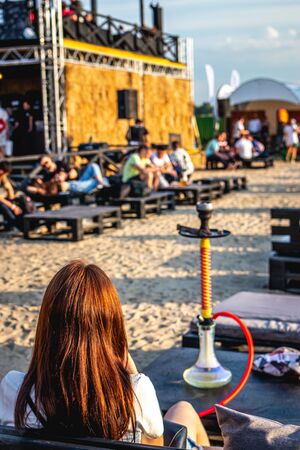 Young woman vaping outdoors. Woman with hookah.の写真素材