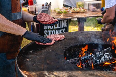 MOSCOW, RUSSIA - JULY 27, 2019: Closeup of grilled burger cutlets. Burger barbeque. BBQ, grilling, fire.のeditorial素材