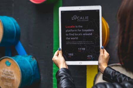 MOSCOW, RUSSIA - AUGUST 18, 2019: Woman hands holding iPad PRO tablet on the street background.のeditorial素材
