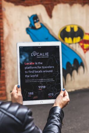 MOSCOW, RUSSIA - AUGUST 18, 2019: Woman hands holding iPad PRO tablet on the street background.のeditorial素材