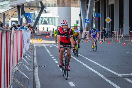 MOSCOW, RUSSIA - AUGUST 25, 2019: Ironman Cycling competition, cyclist athletes riding a race. Ironstar Crocus Fitness Triathlon.のeditorial素材