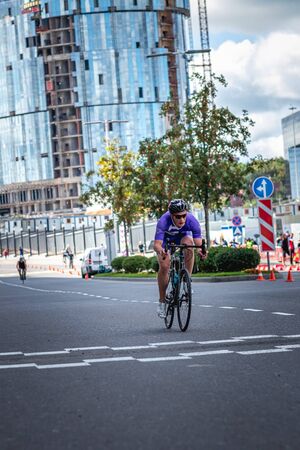 MOSCOW, RUSSIA - AUGUST 25, 2019: Ironman Cycling competition, cyclist athletes riding a race. Ironstar Crocus Fitness Triathlon.のeditorial素材