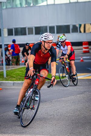 MOSCOW, RUSSIA - AUGUST 25, 2019: Ironman Cycling competition, cyclist athletes riding a race. Ironstar Crocus Fitness Triathlon.のeditorial素材