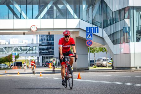 MOSCOW, RUSSIA - AUGUST 25, 2019: Ironman Cycling competition, cyclist athletes riding a race. Ironstar Crocus Fitness Triathlon.のeditorial素材