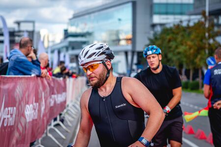 MOSCOW, RUSSIA - AUGUST 25, 2019: Ironman Cycling competition, cyclist athletes riding a race. Ironstar Crocus Fitness Triathlon.のeditorial素材