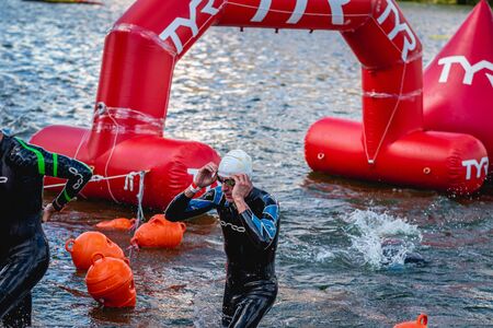 MOSCOW, RUSSIA - AUGUST 25, 2019: Ironman Swimmers on the open waters event Moscow river. Ironstar Crocus Fitness Triathlon 2019.のeditorial素材