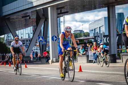 MOSCOW, RUSSIA - AUGUST 25, 2019: Ironman Cycling competition, cyclist athletes riding a race. Ironstar Crocus Fitness Triathlon.のeditorial素材