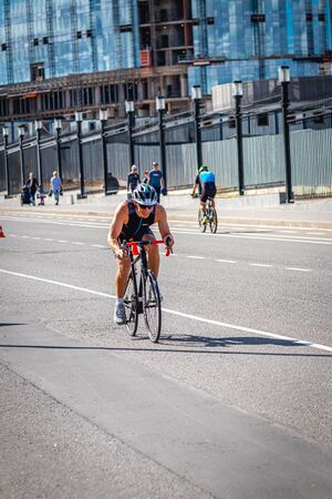 MOSCOW, RUSSIA - AUGUST 25, 2019: Ironman Cycling competition, cyclist athletes riding a race. Ironstar Crocus Fitness Triathlon.のeditorial素材
