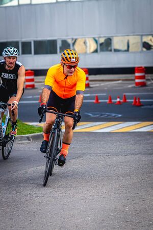 MOSCOW, RUSSIA - AUGUST 25, 2019: Ironman Cycling competition, cyclist athletes riding a race. Ironstar Crocus Fitness Triathlon.のeditorial素材