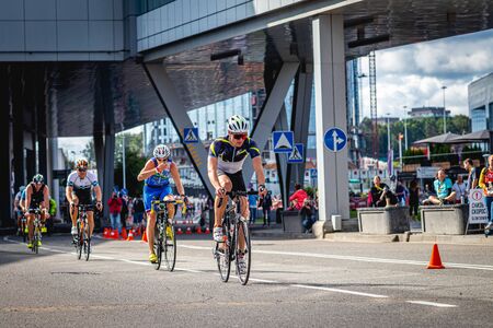 MOSCOW, RUSSIA - AUGUST 25, 2019: Ironman Cycling competition, cyclist athletes riding a race. Ironstar Crocus Fitness Triathlon.のeditorial素材