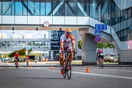 MOSCOW, RUSSIA - AUGUST 25, 2019: Ironman Cycling competition, cyclist athletes riding a race. Ironstar Crocus Fitness Triathlon.のeditorial素材