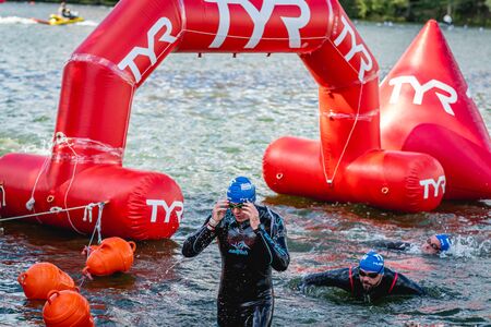 MOSCOW, RUSSIA - AUGUST 25, 2019: Ironman Swimmers on the open waters event Moscow river. Ironstar Crocus Fitness Triathlon 2019.のeditorial素材