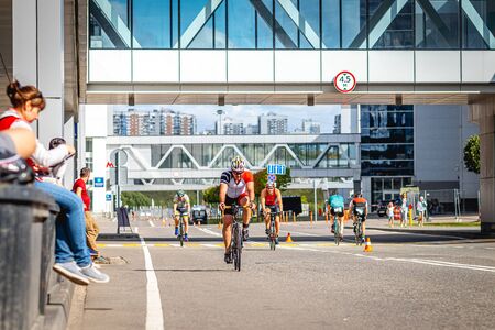 MOSCOW, RUSSIA - AUGUST 25, 2019: Ironman Cycling competition, cyclist athletes riding a race. Ironstar Crocus Fitness Triathlon.のeditorial素材