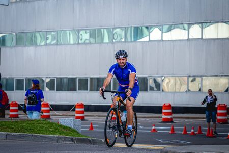 MOSCOW, RUSSIA - AUGUST 25, 2019: Ironman Cycling competition, cyclist athletes riding a race. Ironstar Crocus Fitness Triathlon.のeditorial素材