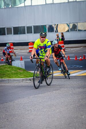 MOSCOW, RUSSIA - AUGUST 25, 2019: Ironman Cycling competition, cyclist athletes riding a race. Ironstar Crocus Fitness Triathlon.のeditorial素材